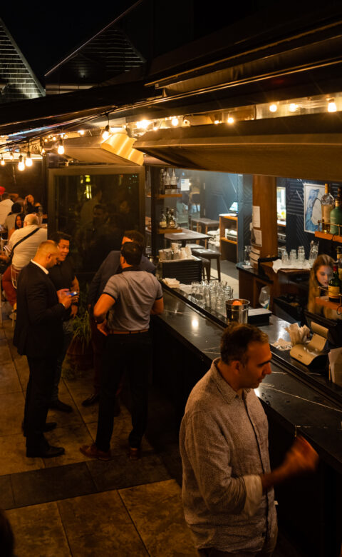 The Broadview Hotel Rooftop bar surrounded by people enjoying a nighttime