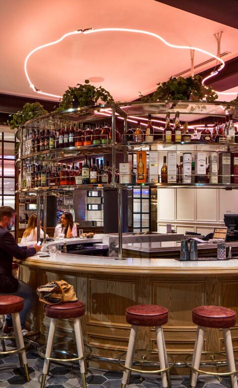 bar rendering with round stools bathed in red light from above