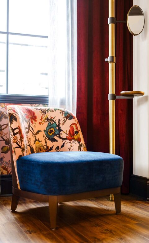 chair with floral backing in front of window