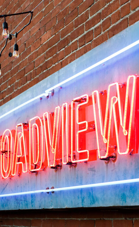 lit neon blue and orange the broadview hotel sign