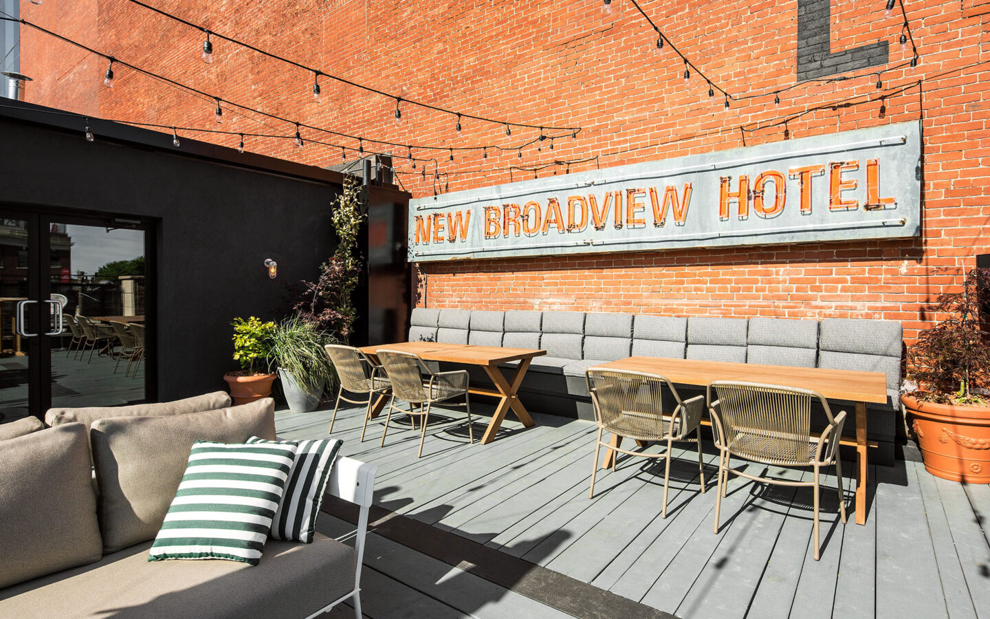 rooftop seating area with seating and new broadview hotel sign