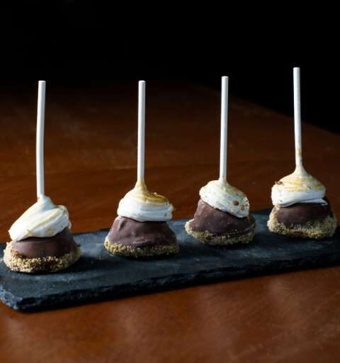 four lollipop type desserts