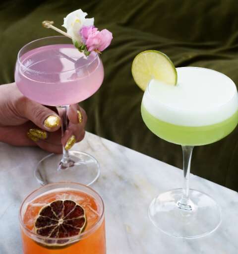 three cocktails on a table