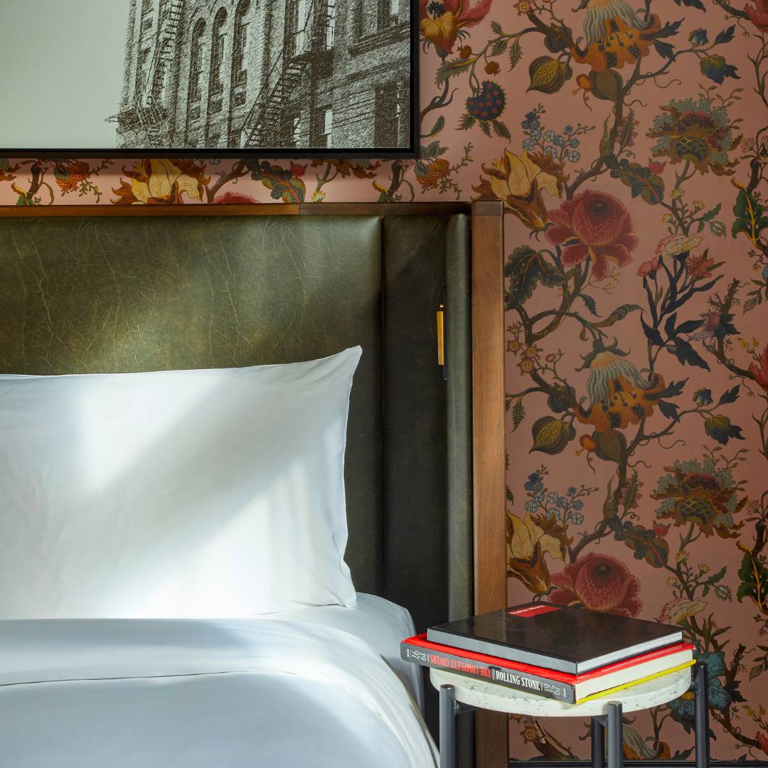 Books kept on a table next to a bed