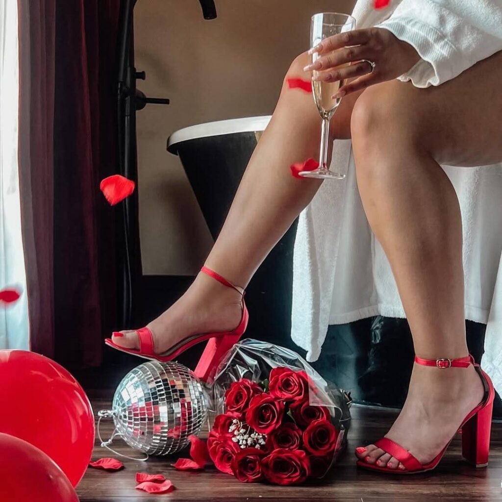 a woman sitting on a chair with a glass of wine